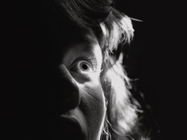Black and white portrait of a scared woman