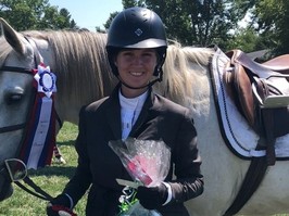 Sydney, diagnosed with thoracic-outlet-syndrome next to a horse