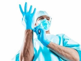 doctor putting latex glove on