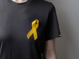 yellow ribbon on black shirt