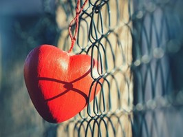 heart hanging on fence