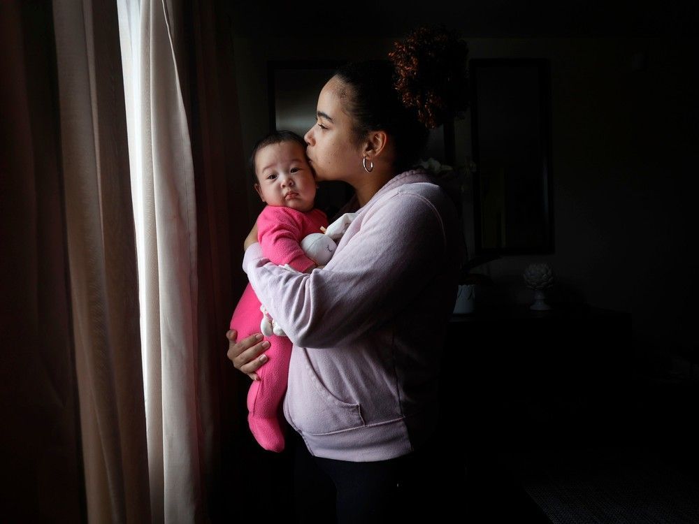 ottawa - march 28, 2023 - jessica kiala poses for a photo with her daughter deborah at their home in ottawa tuesday. jessica is a young single mom - a refugee from angola - who has received support from ottawa public health's healthy babies, healthy children program which is having difficulty keeping up with demand. tony caldwell, postmedia.