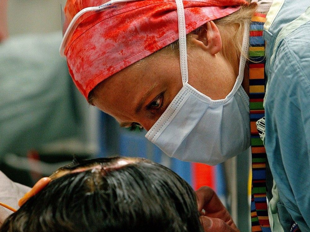 a nurse speaks with a patient at the university of alberta hospital in edmonton.