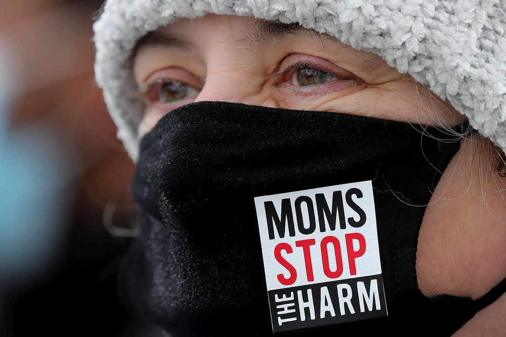 angela welz, board member with moms stop the harm, takes part in a protest organized by albertans for ethical drug policy at the alberta legislature in edmonton on feb. 23, 2022.