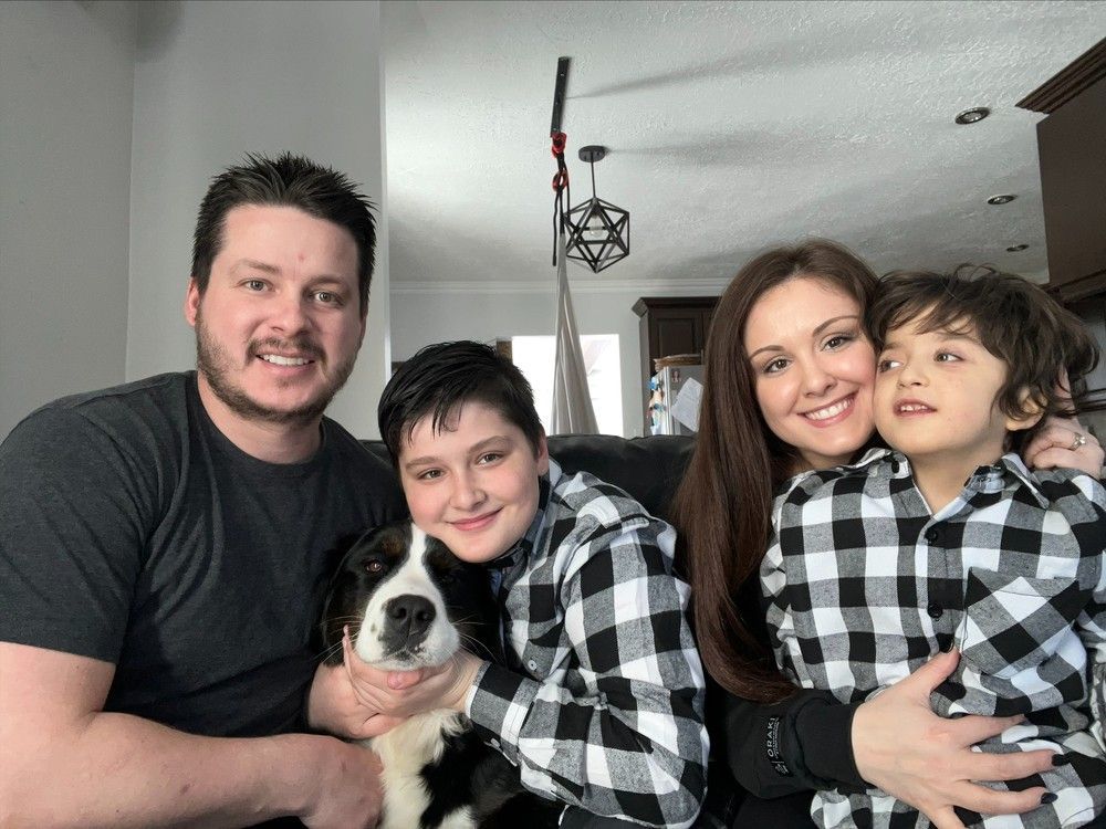 Thomas Thériault in the fall of 2022, shortly before his seventh birthday and before his health took a serious downturn, with parents Jean-Rock Thériault and Marie-Michèle Arpin, brother Lucas Thériault and their dog Rosie. “He’s always smiling," Arpin says. "Even if it’s not going well, he looks for a reason to laugh to make us feel better."