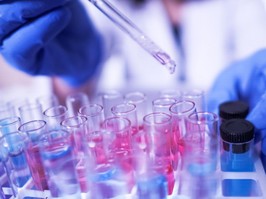 a scientist filling test tubes