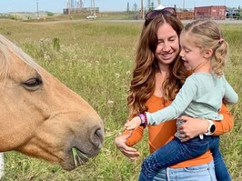 Julia and Elsie Irwin feeding a horse