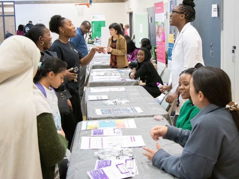 eniola salami, right, assistant professor in the faculty of medicine and dentistry takes questions at the health fair on sunday, april 30, 2023. the black medical student association of the university of alberta hosted the at the castle downs ymca in edmonton. fifteen booths were set up to educate attendees on how to stay healthy and detect health problems early.