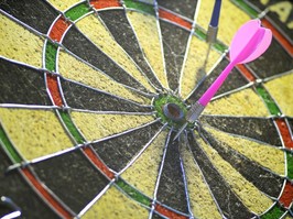 dartboard with darts missing target