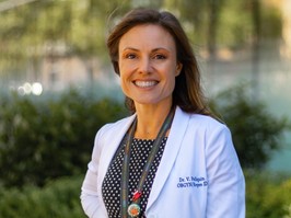 Vanessa Poliquin, OBGYN, in a white lab coat standing outside, spoke to healthing aobut how to treat, and avoid, yeast infections
