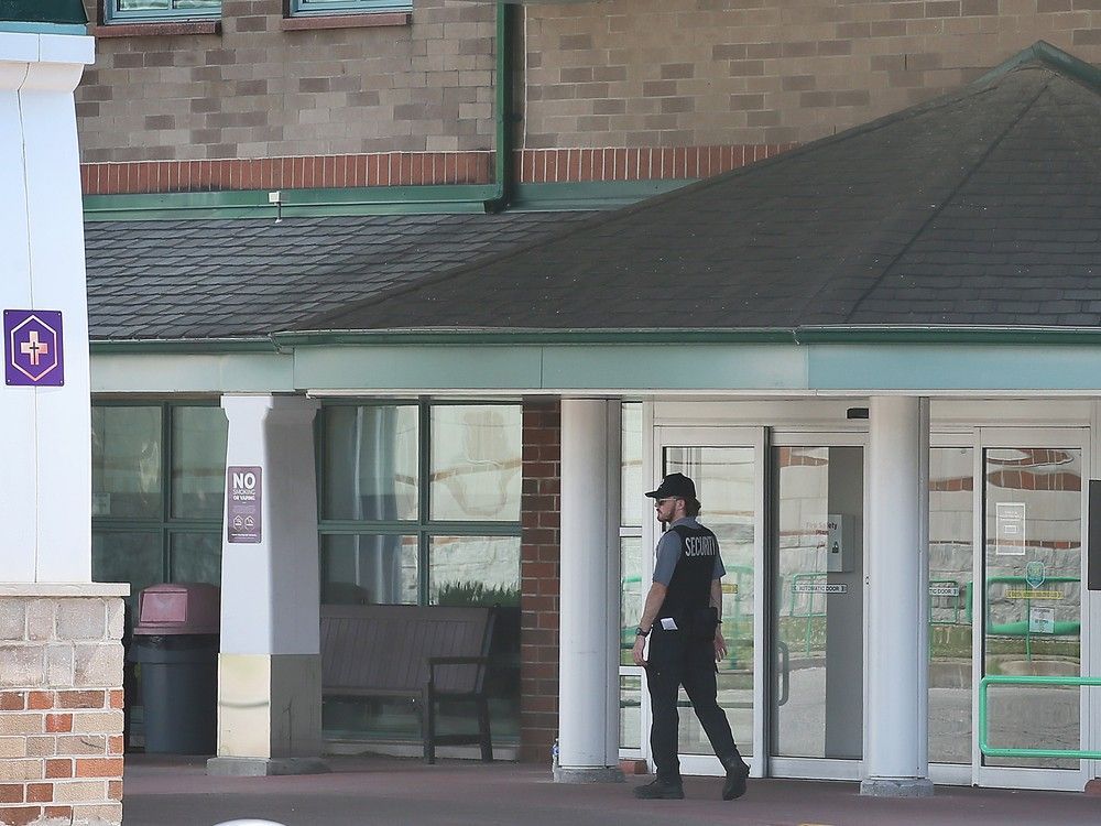 A security guard is shown at the main entrance of the Emara building at Hotel-Dieu Grace Healthcare in Windsor on Wednesday, June 21, 2023.