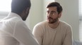 Man sitting with his doctor discussing his prostate cancer diagnosis.