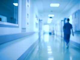 man walking down hospital hall