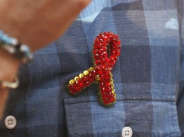 Red brooch of the symbol for HIV/AIDS awareness