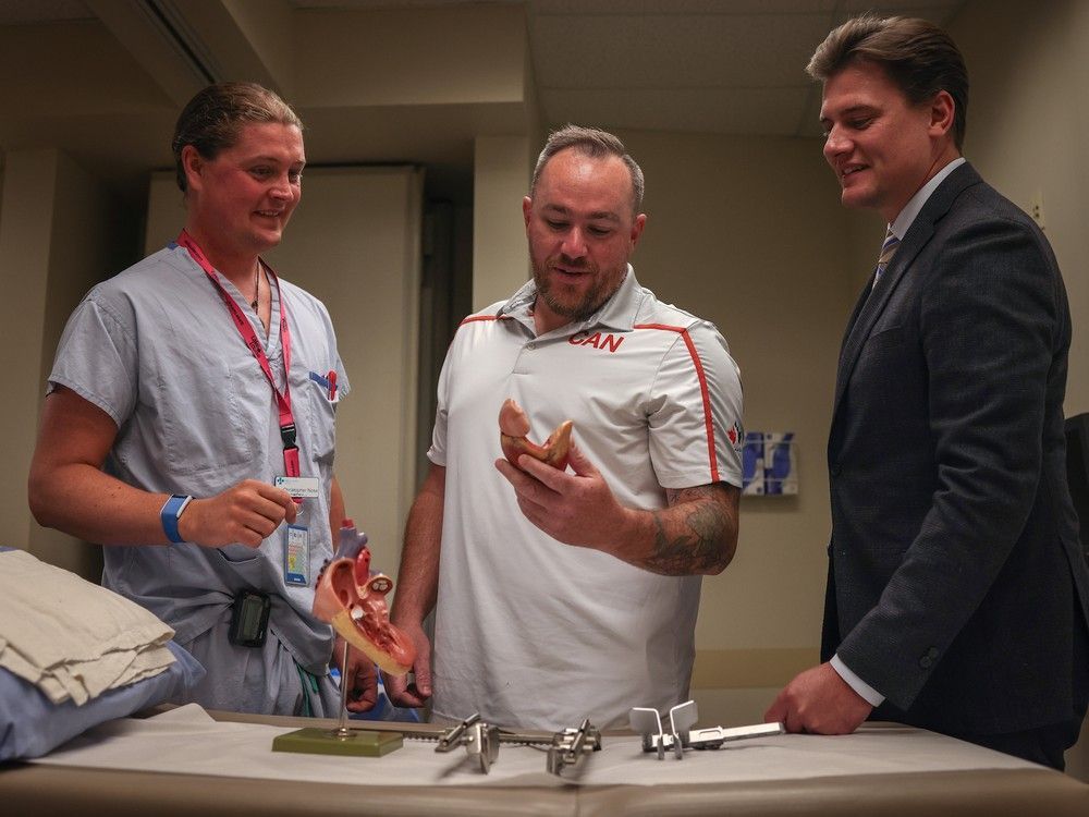 cardiac anesthesiologist dr. christopher noss, left, with chris kennedy, 40, and cardiac surgeon dr. daniel holloway. kennedy was the second patient in the province to undergo a novel, minimally invasive cardiac procedure that dramatically reduces recovery time. july 17, 2023 in calgary, alta.