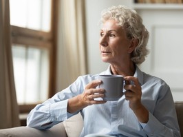 older woman looking out window