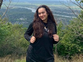 Nesrine Aboulhamid - young girl posing for a picture while on a hike.