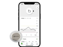 Mobile phone displaying glucose monitoring app interface