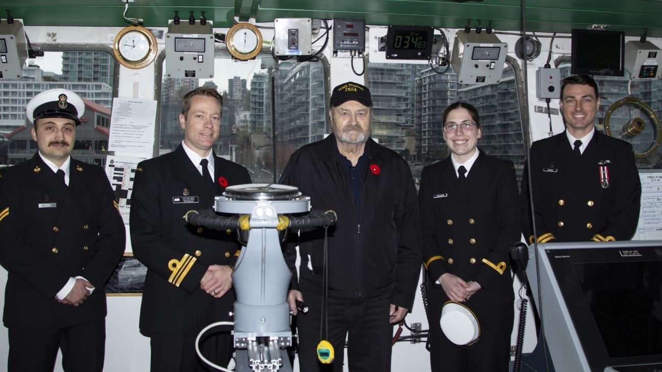 Eric Small, centre, with members of the HMCS Edmonton in November 2022.