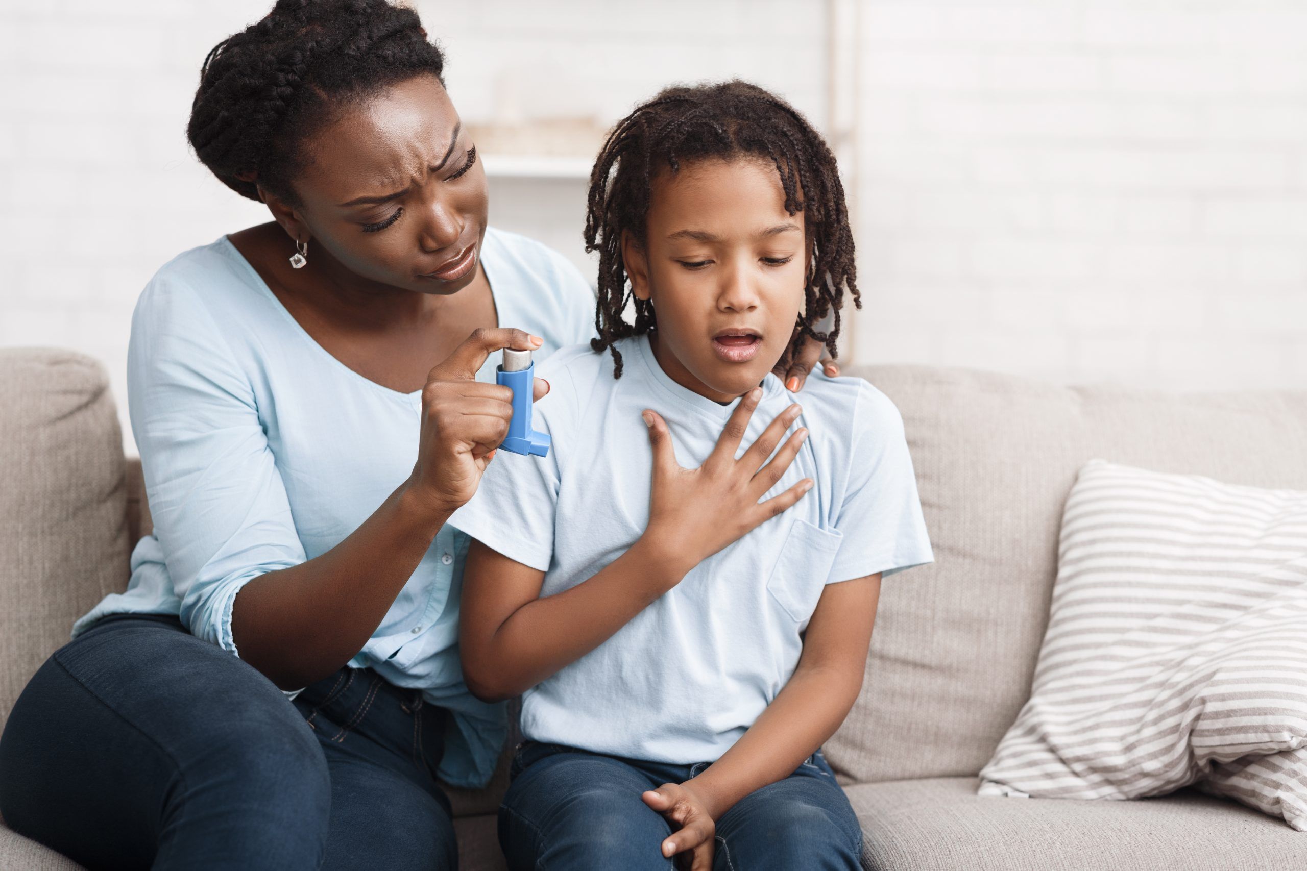 African Girl Having Asthma Attack, Worried Mom Giving Her Inhaler For Relief. Copy space