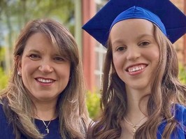 Close up photo of mother and daughter at graduation ceremony. Lisa and Rachael Wright.