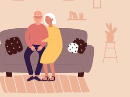 elderly couple sitting together on couch