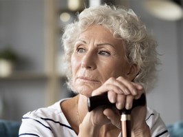 Women holding cane looking out