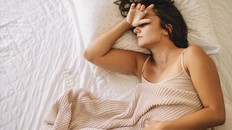 Sick young woman in bed. Woman have menstrual pain.