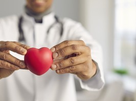 Doctor holding red heart. Selective focus, man's hands in close-up. Concept of good health, cardiovascular diseases prevention, healthy lifestyle promotion, human organ donation, implantation