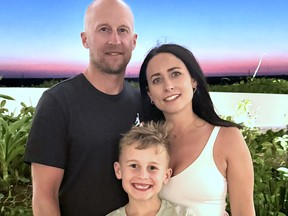 Mike, Cindy, and Mason Howard pose for a family photo.