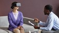 Young woman wearing virtual reality headset when having therapy session