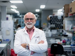 Dr. Michael Strong standing in his lab with his arms crossed