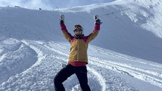Dr. Shazma Mithani middle aged woman skiiing on a hill with her arms raised