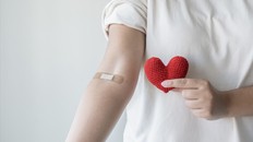Blood donation concept. Give blood save up to three lives. Woman arm with the bandage plaster showing as a blood donation volunteer.