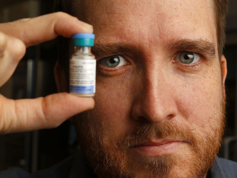 dr. trevor arnason, ottawa's interim medical officer of health, displays a vial of measles vaccine.