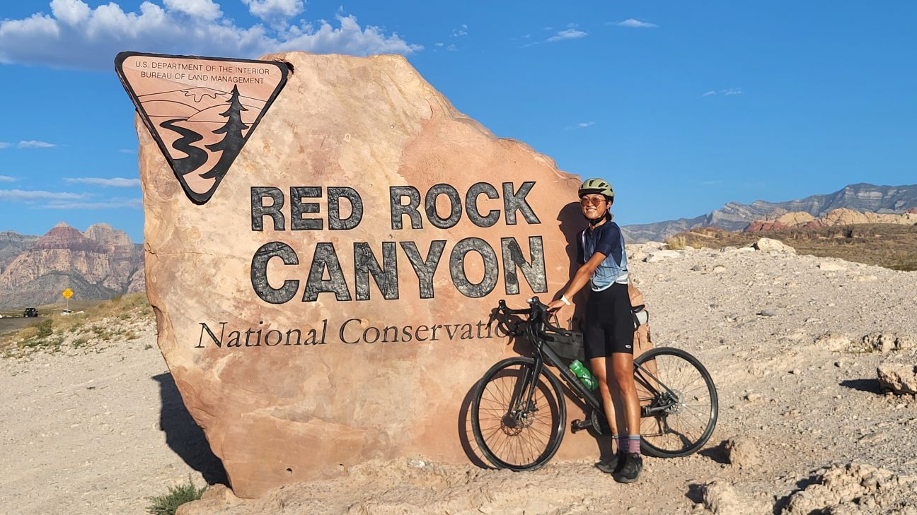 Li Jiang - young woman riding a bike and posing for a photo at Red Rock Canyon.