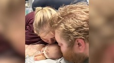 Kayla Hickey and her husband, Ryan Bowering, share a moment with their son, Declan, while he was receiving critical care in hospital in late 2023. Declan died at 25 days old after a bacterial infection.