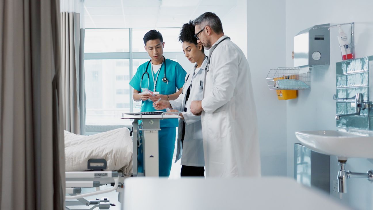 Healthcare, hospital and a medical team of doctors checking on a patient in recovery or rehabilitation.