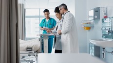 Healthcare, hospital and a medical team of doctors checking on a patient in recovery or rehabilitation.