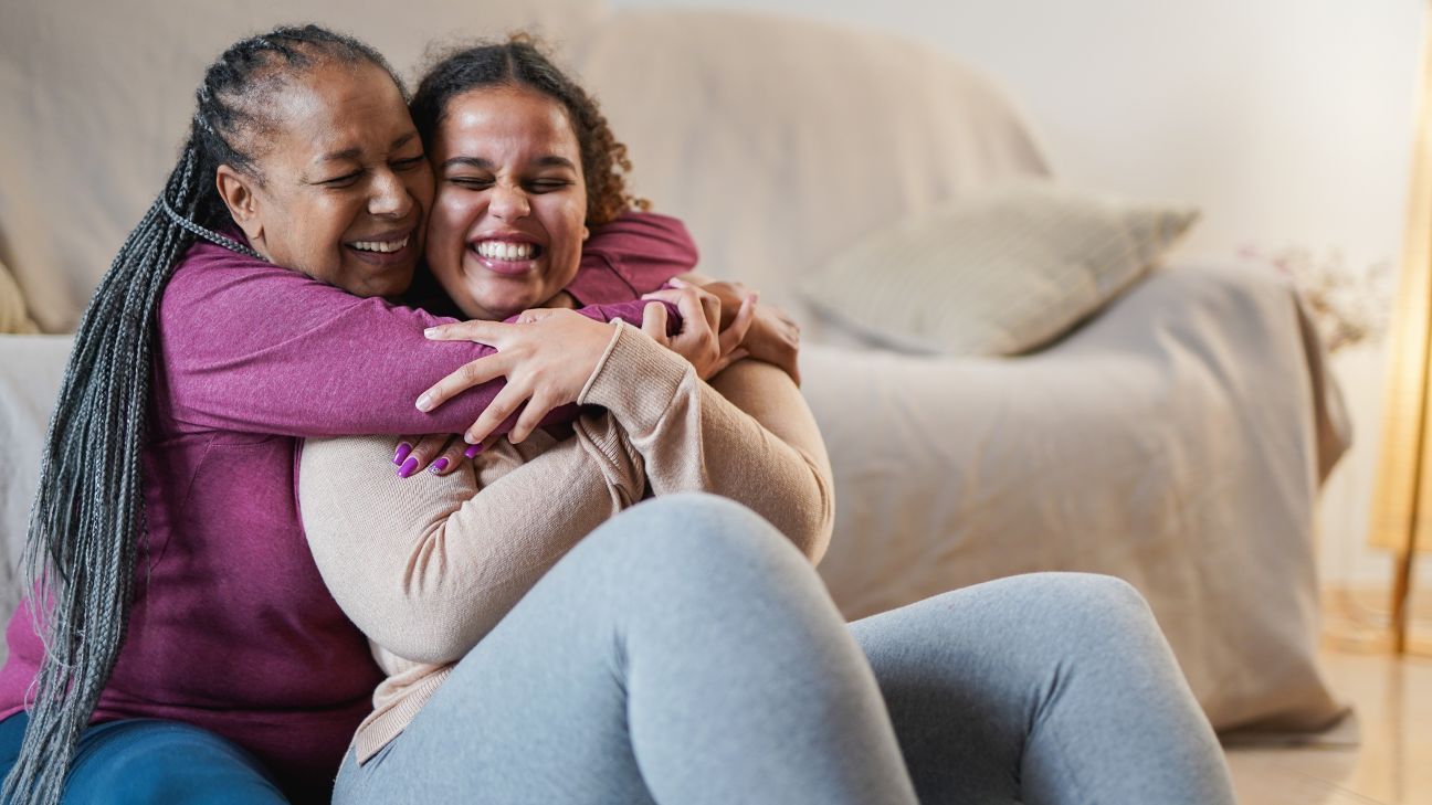Two Black women hugging and sharing a happy moment. Mother and daughter.
