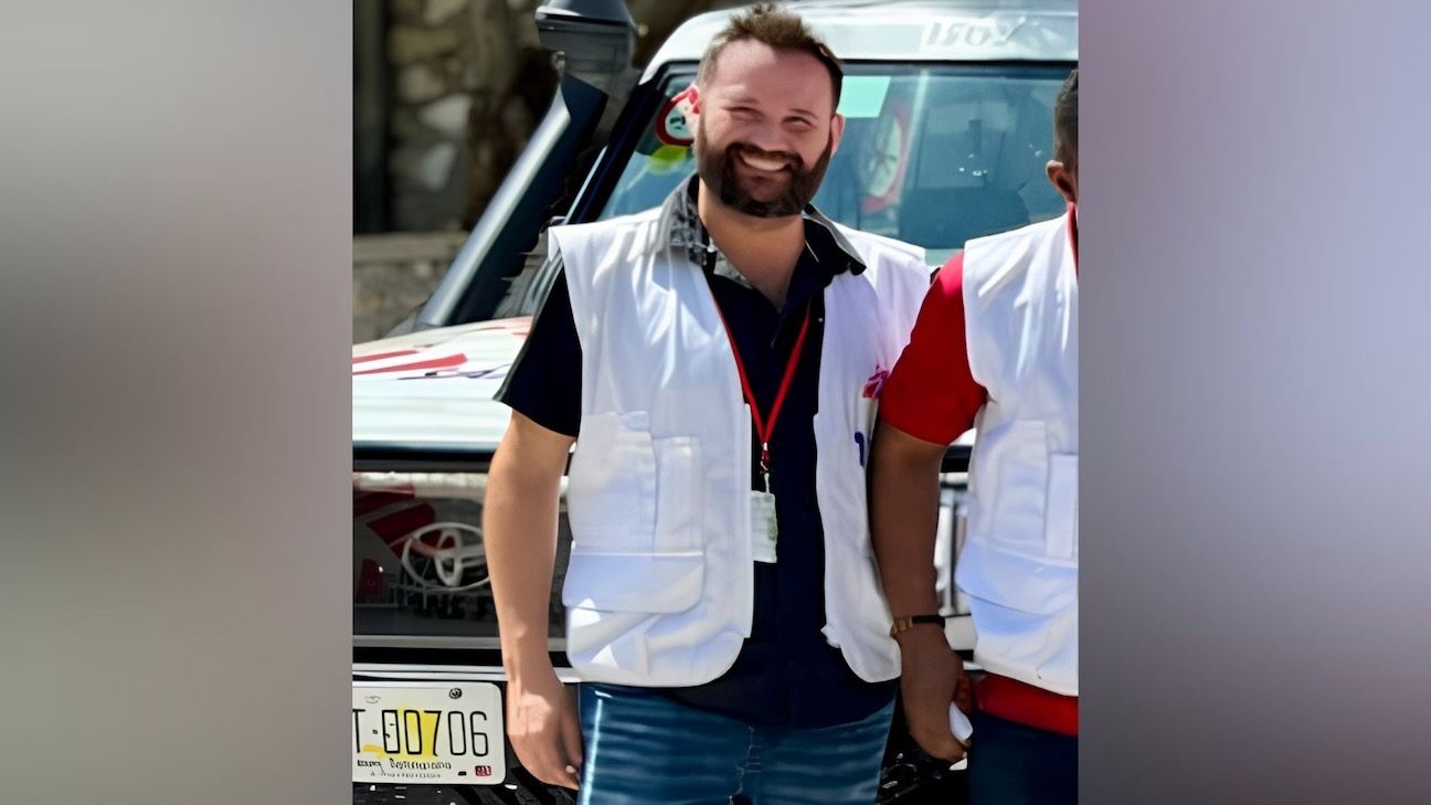 Kévin Allard, medical laboratory technician, poses for a photo in uniform. Middle aged man with beard posing for a photo.