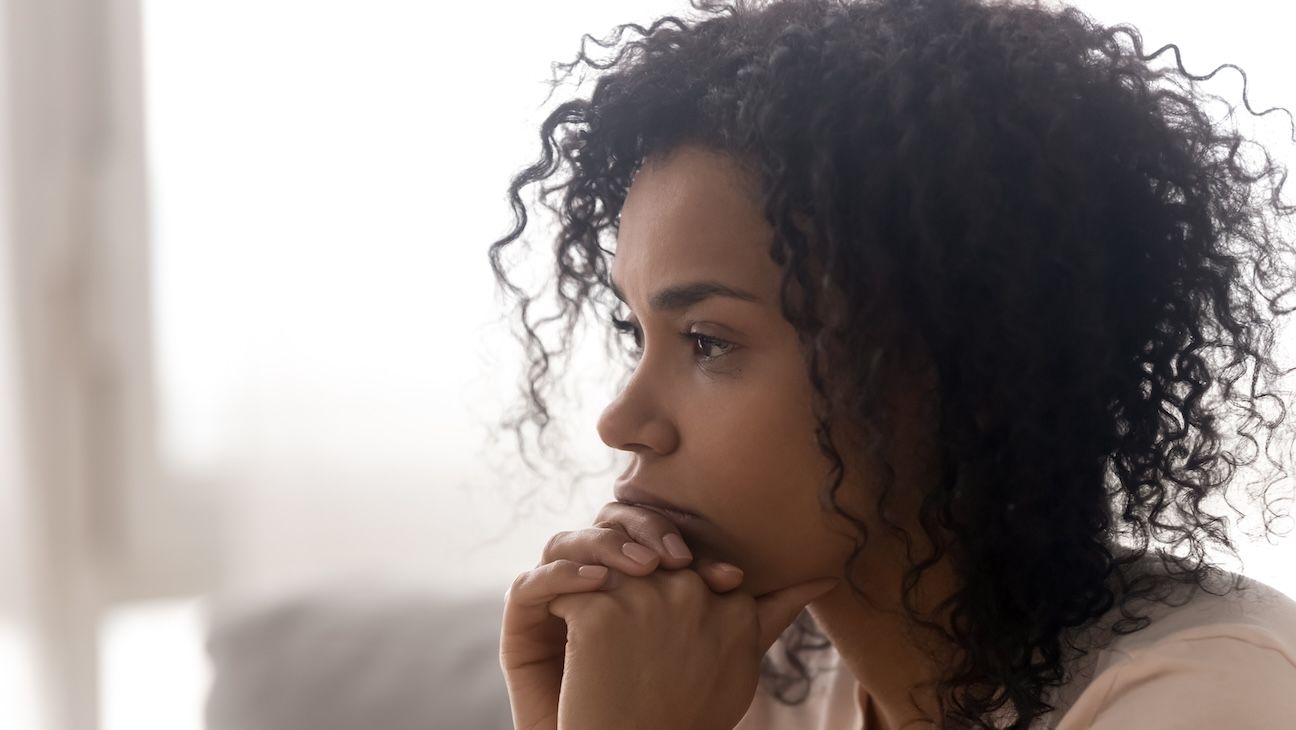Black woman looking off into the distance. Close up of face.
