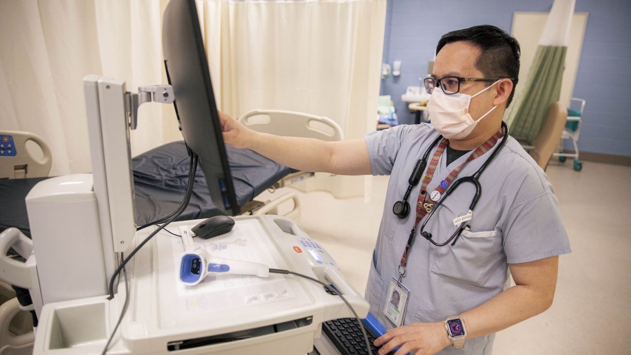 Domino Puson, nurse working on a machine at a hospital.