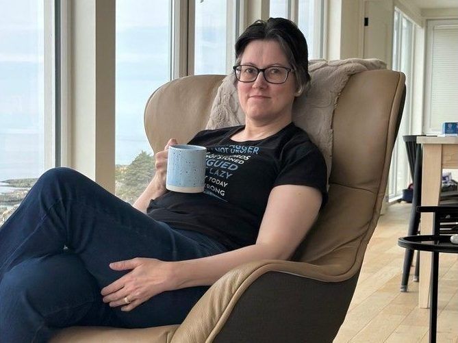 Woman relaxing in comfy chair.
