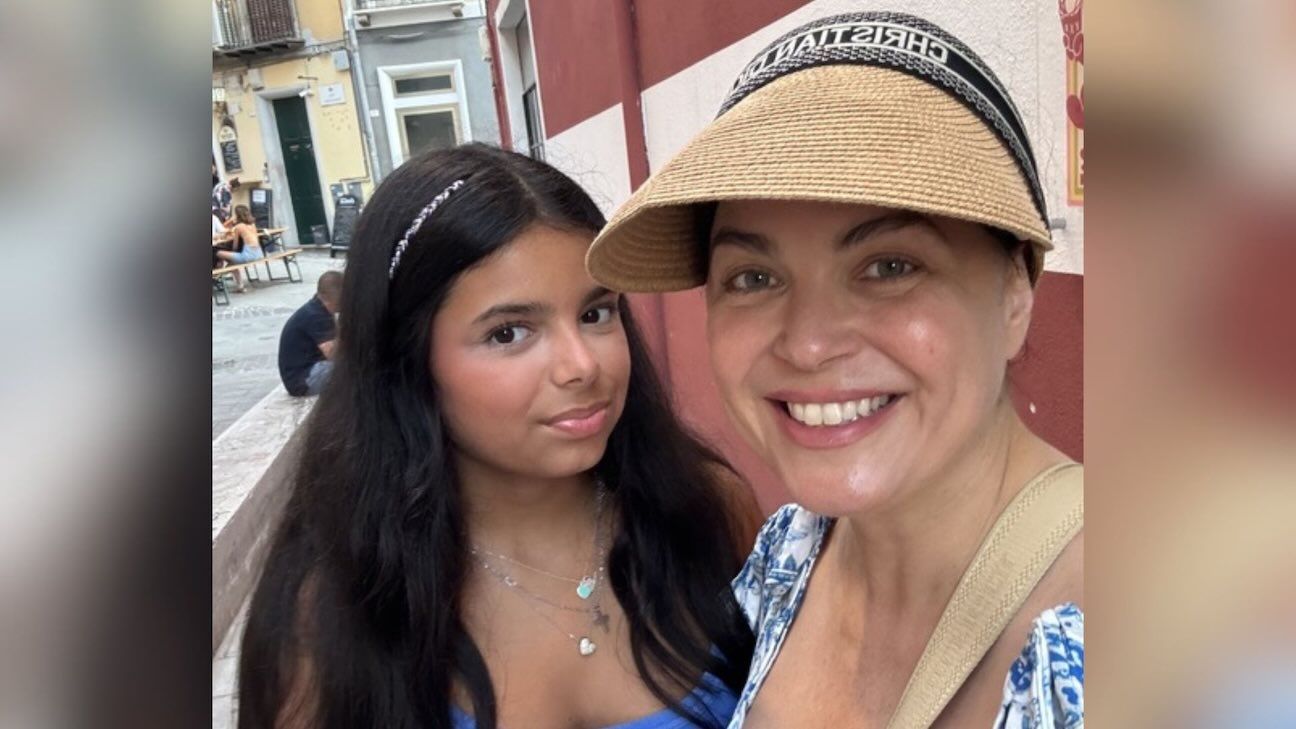 A close up photo of a woman, Sandra Elia, and her daughter Sophia, smiling in the camera.