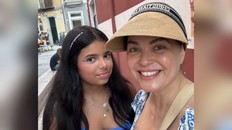 A close up photo of a woman, Sandra Elia, and her daughter Sophia, smiling in the camera.