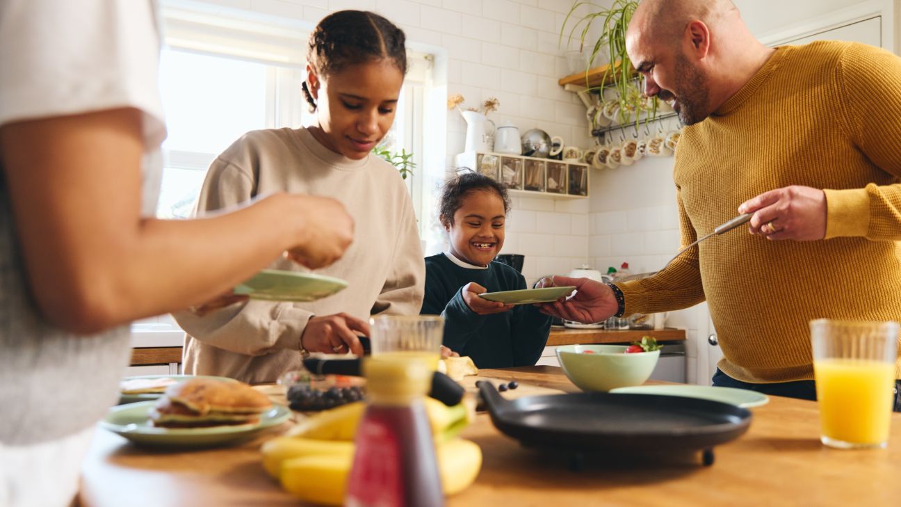 Family eats breakfast together.