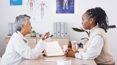 doctor with black woman in office for medical, checklist and results.