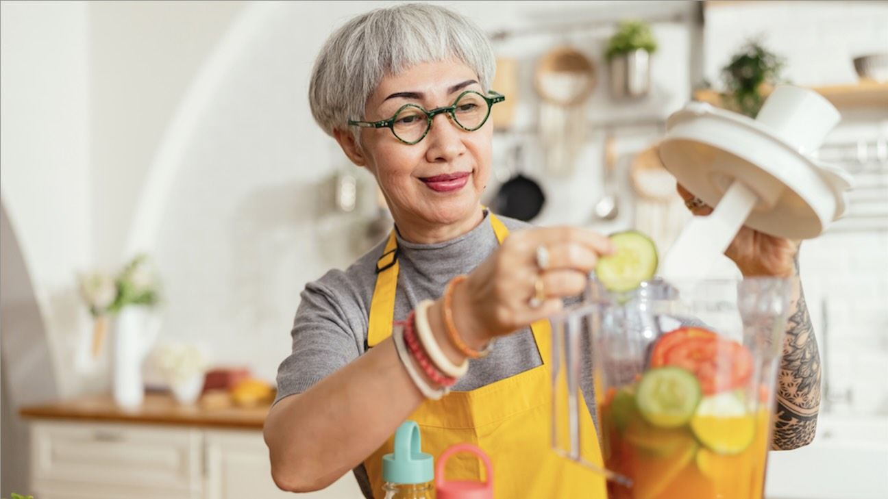 healthy asian aunt retired female woman enjoy making cook clean food breakfast for her healthy food lifestyle,smiling cheerful woman silver hair with tattoo prepare smoothie juice drink for her health