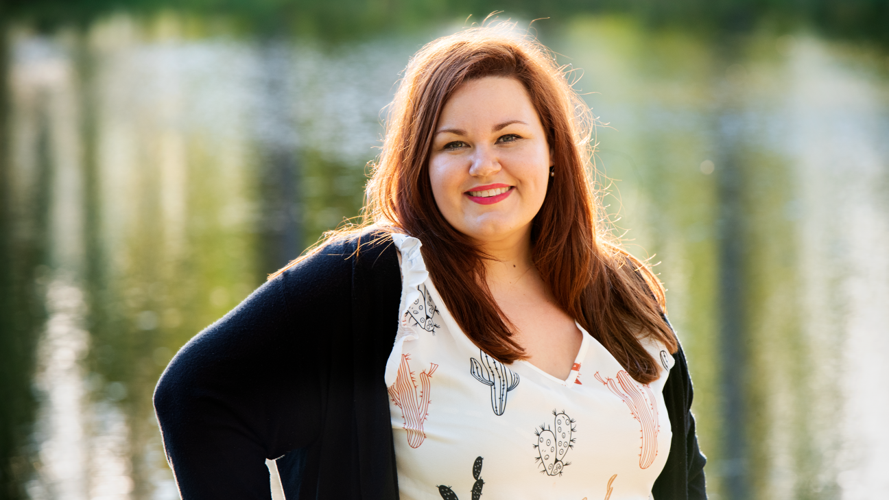 Woman poses for a photos outdoors.